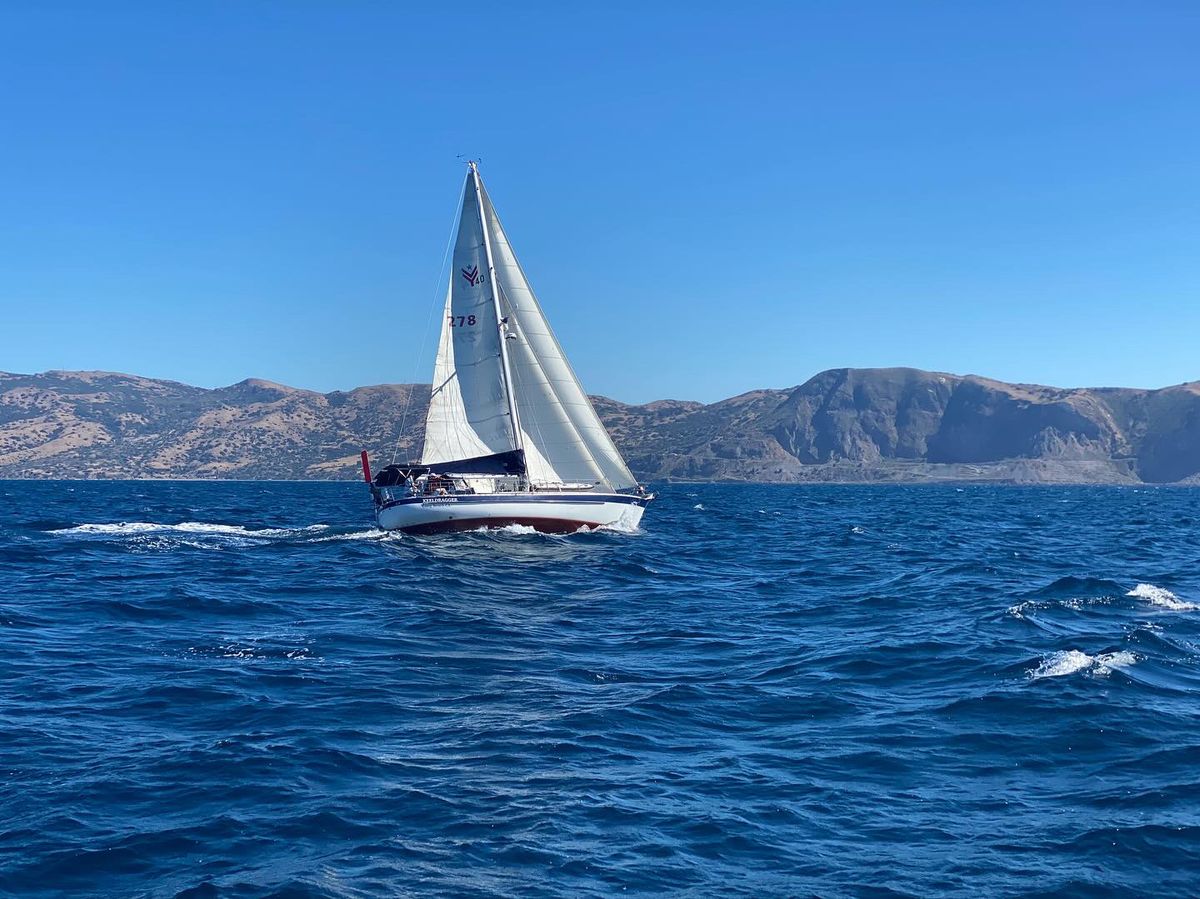Keeldragger under full sail on a breezy blue day, the hills of Catalina Island astern.